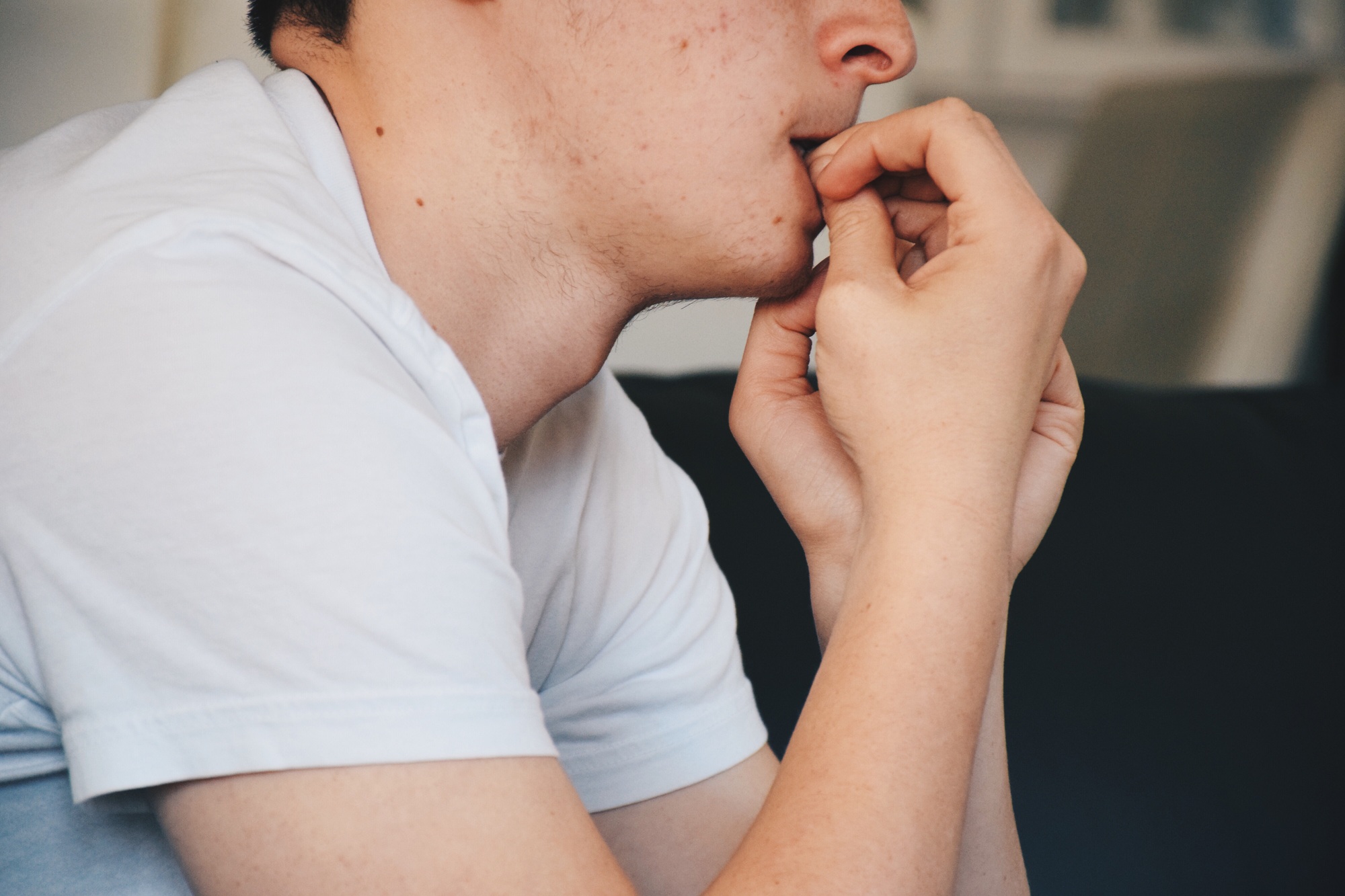 Teenager feeling anxious and nervous biting nails